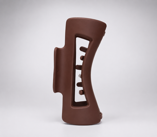 Brown ceramic vase with unique design on a white background